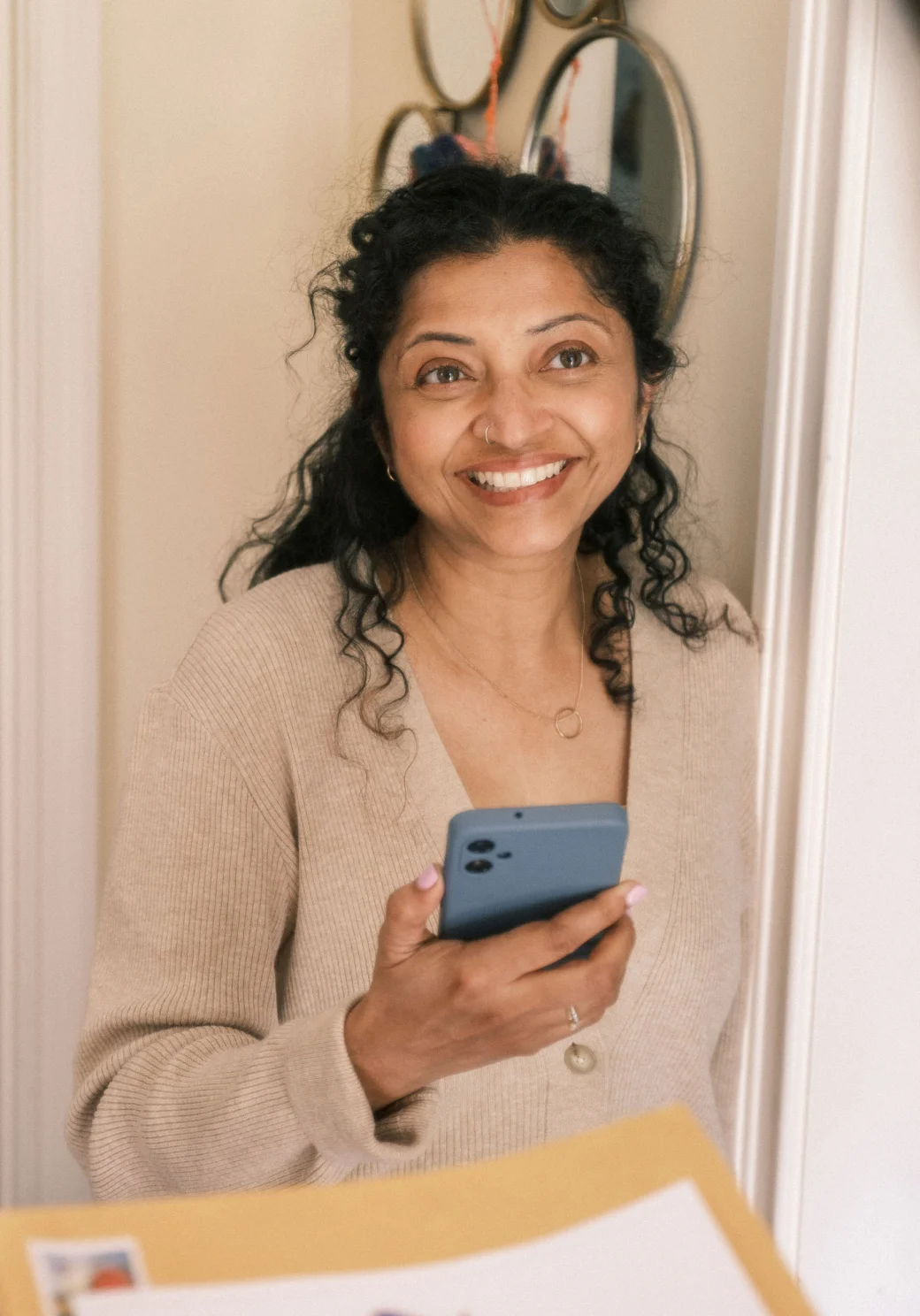 A young woman looks forward while her phone is in her hand.