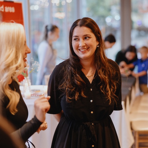 Employees from Rocket speaking to each other during a work event.