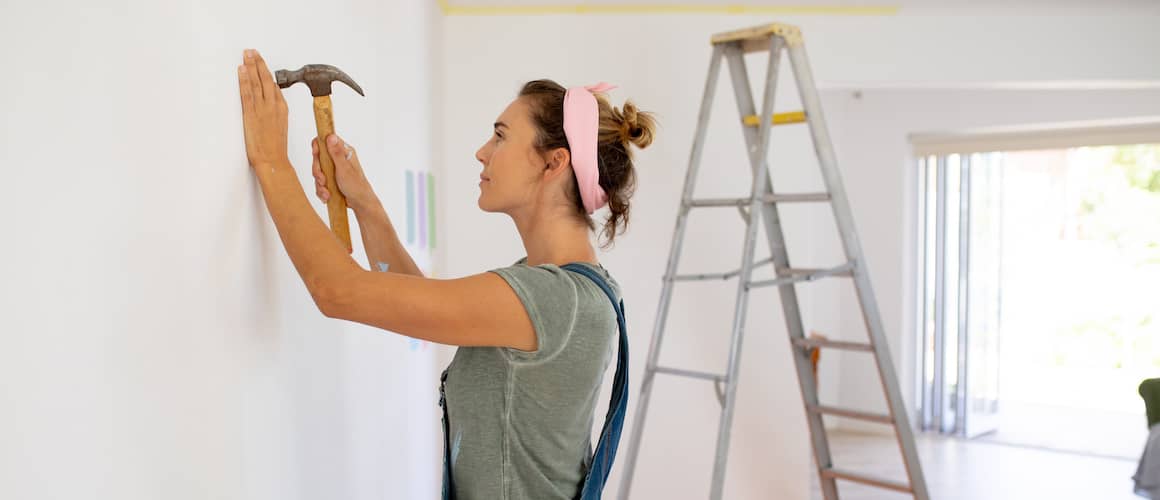 A woman engaged in a DIY project, indicating home improvement or personalization efforts.