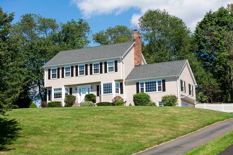 Large colonial-style house on hill.