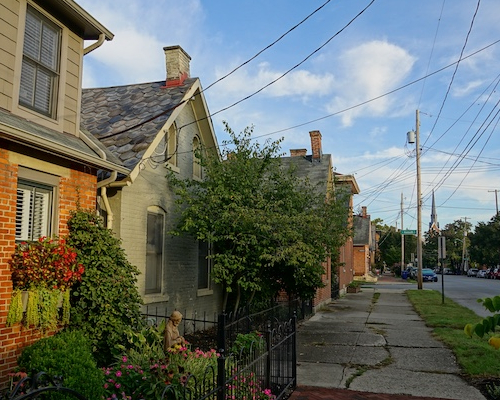 Row of homes along a sidewalk in German Village neighborhood in Ohio.