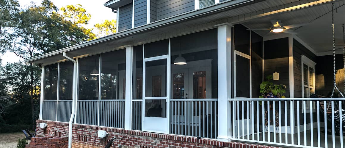 Two story grey house with screen porch