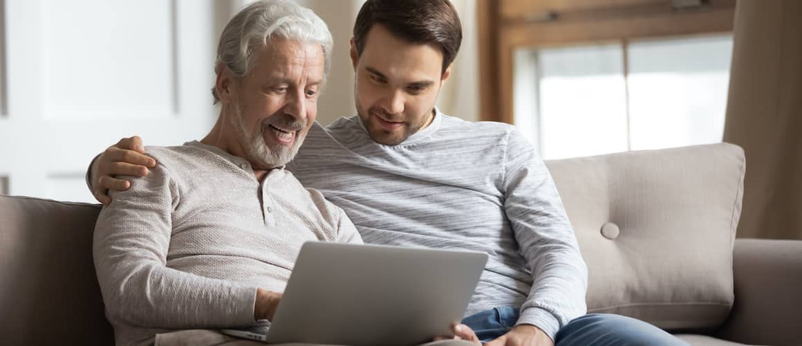 RHB Assets From IGX: Elderly father helping his millennial son search on a computer