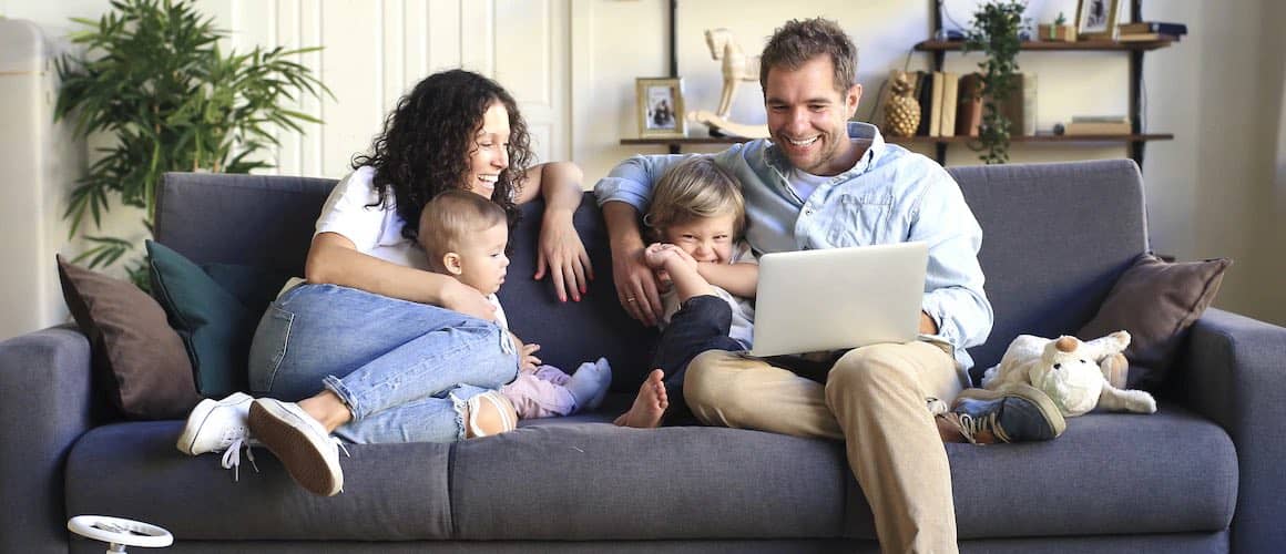 Image of family enjoying home together on couch.