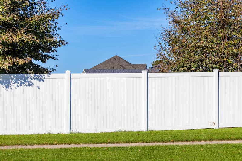 RHB Assets From IGX: A suburban backyard with a stylish vinyl fence providing privacy.