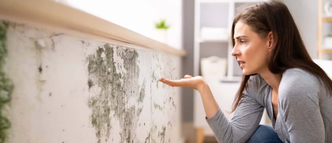 RHB Assets From IGX: A shocked woman looking at mold on a wall