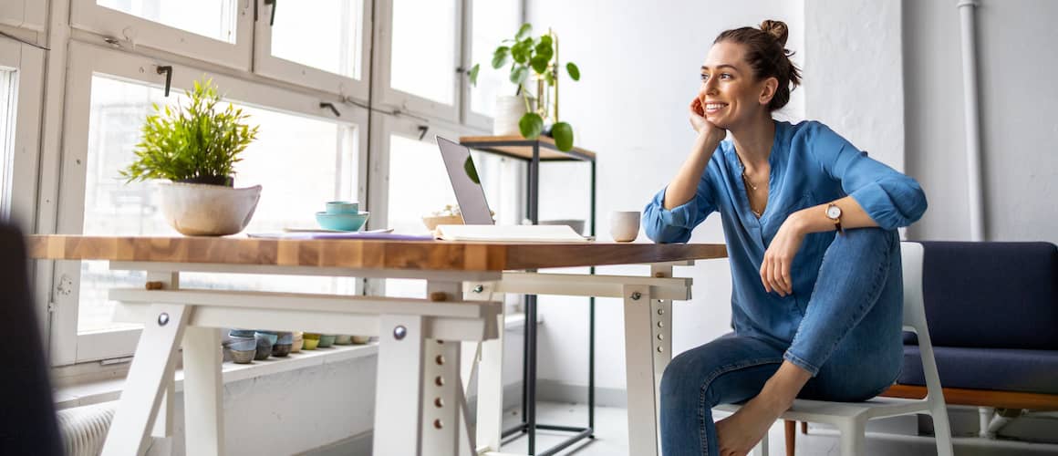 A women possibly working from home engrossed in her thoughts.