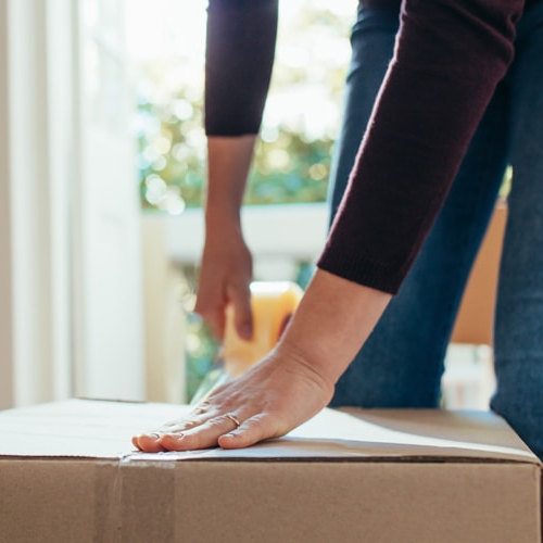 A woman boxing stuff possibly because of shifting to a new house or apartment.