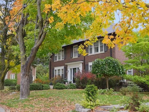 Two story brick home on wooded lot.