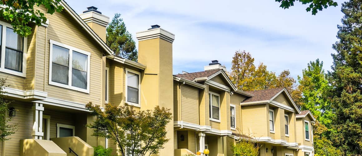 Yellow and white multifamily home.