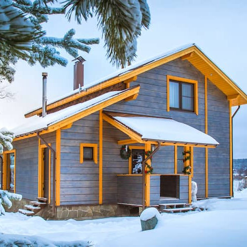 Country cottage, showcasing a cozy rural dwelling with natural surroundings in snowy weather.