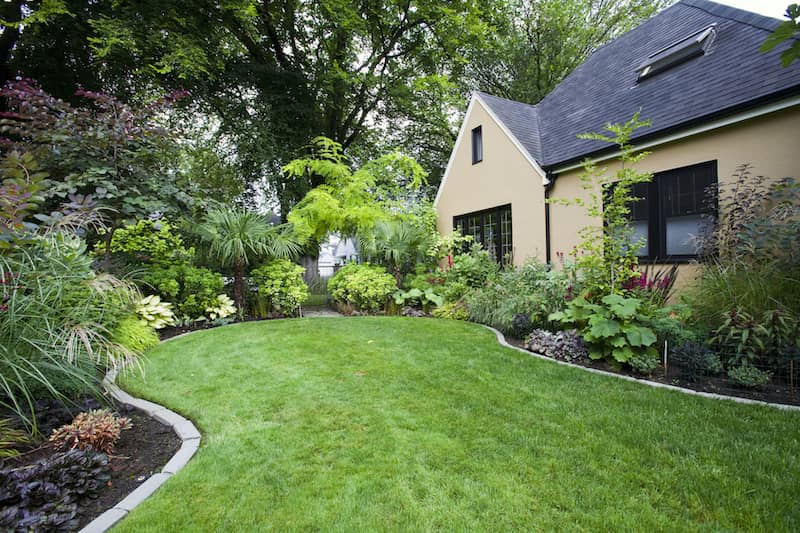 RHB Assets From IGX: Beautiful landscaping with a variety of shrubbery and a well-maintained lawn.