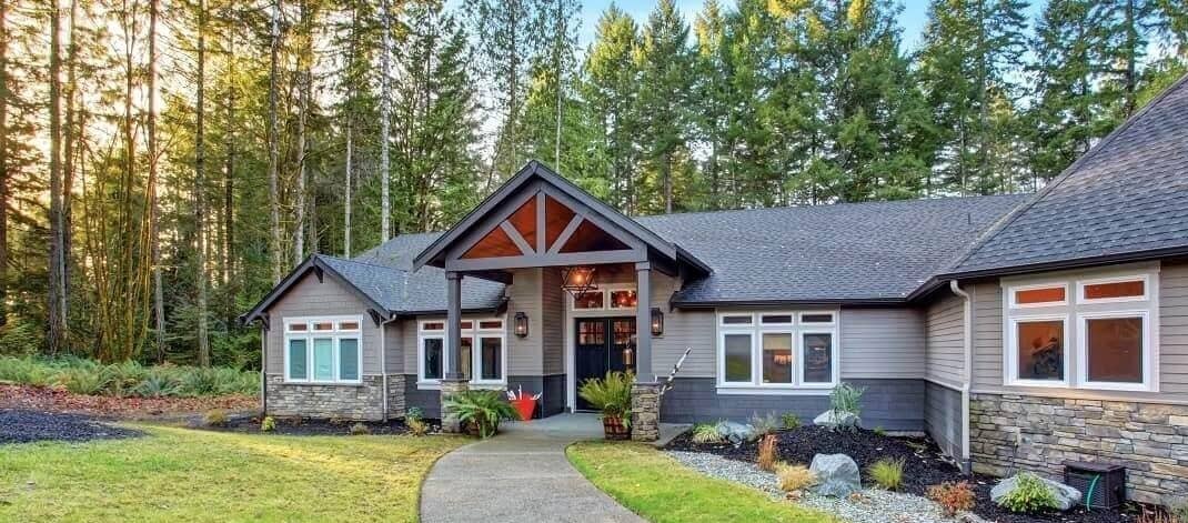 A beautiful house near woods, portraying a serene setting with nature in the background.