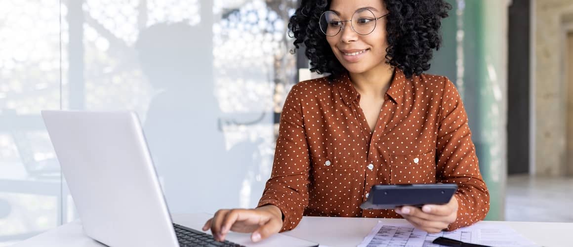 female employee uses calculator at work