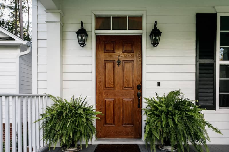 RHB Assets From IGX: Inviting front door with potted plants and a welcoming mat