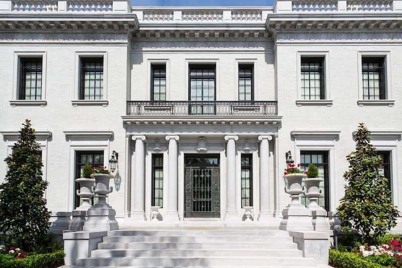 White stone mansion with grand entrance.