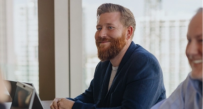 A person is seated, possibly clapping or holding something in their hands.
