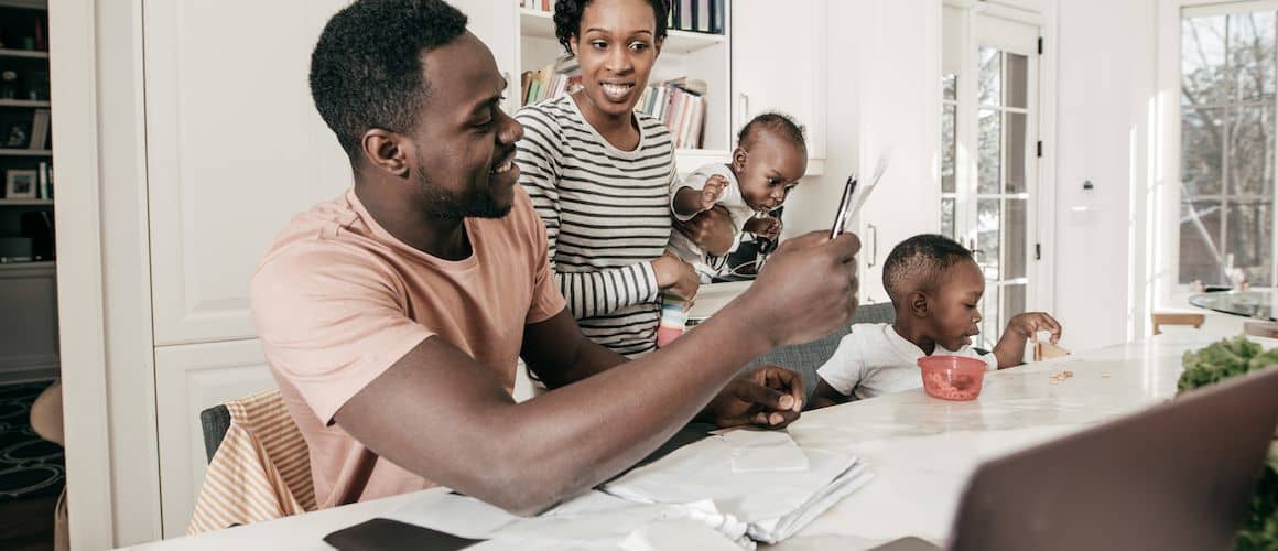 Image of family paying personal loan at kitchen table.