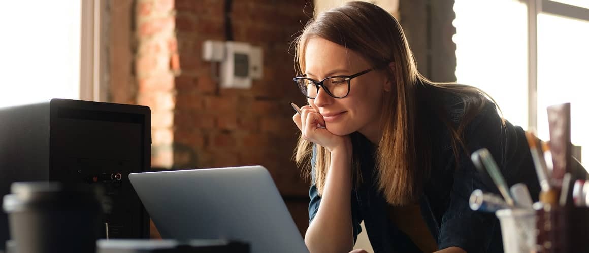 A woman looking at a computer up close, suggesting online research or financial planning.