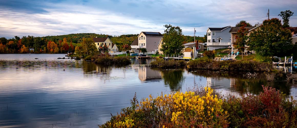 Lake houses or waterfront properties along a serene lake.