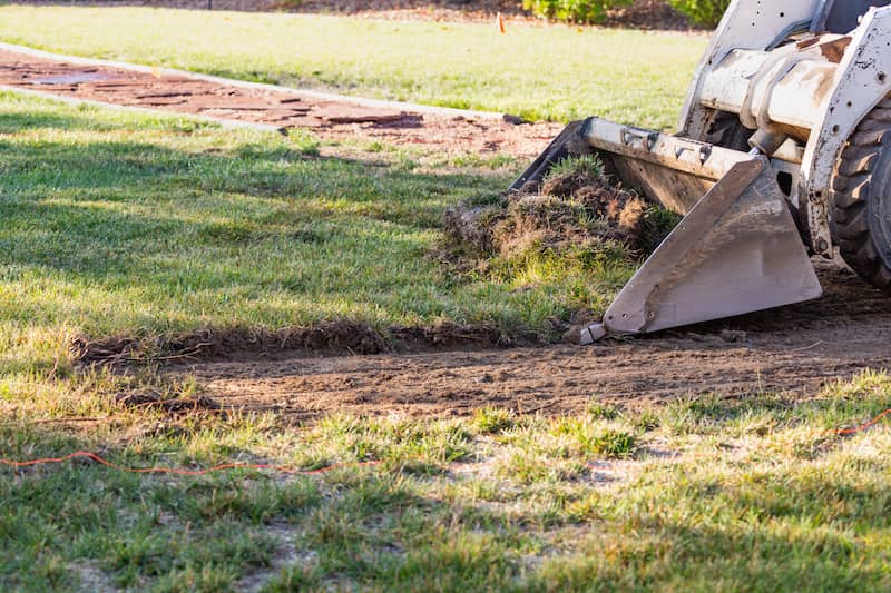 Bulldozer leveling portion of backyard.