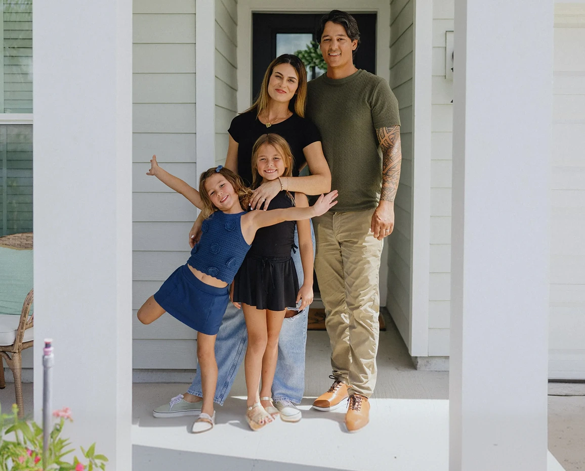 Family standing together in the doorway of a home.