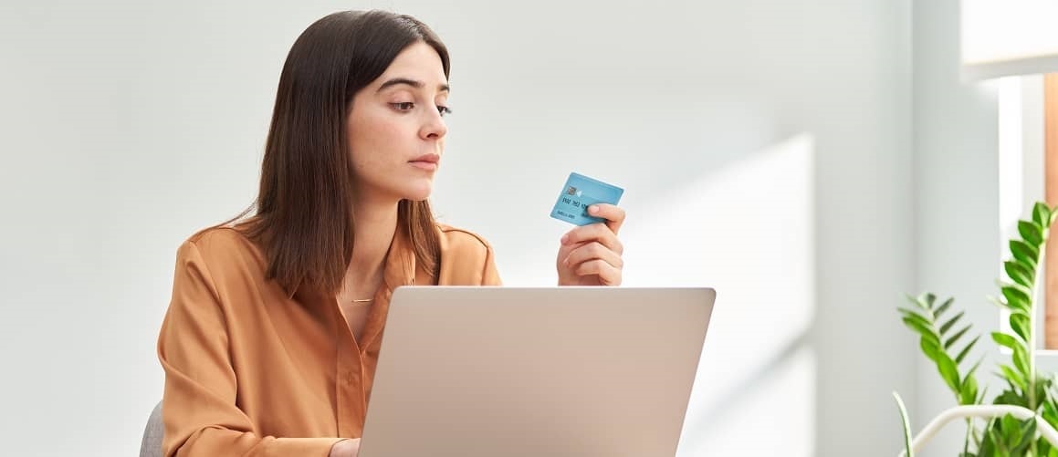 Stock-Woman-Looking-At-CreditCard-AdobeStock-378204983-Copy.jpg