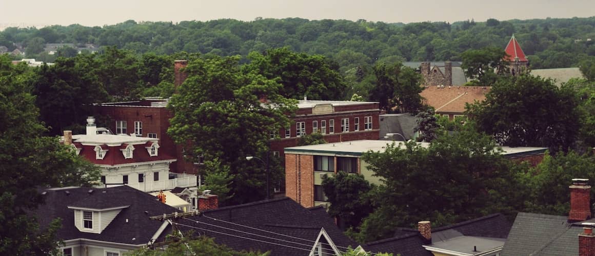 An aerial view of buildings surrounded by trees.