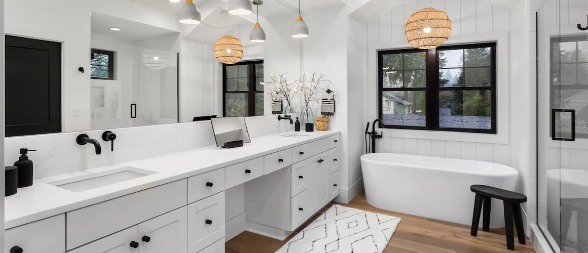 White bathroom remodel with circle lights and basin tub.