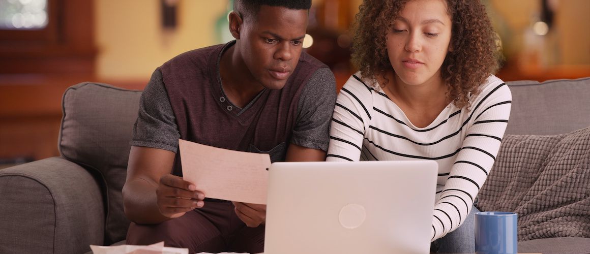 African-American couple looking at expenses.