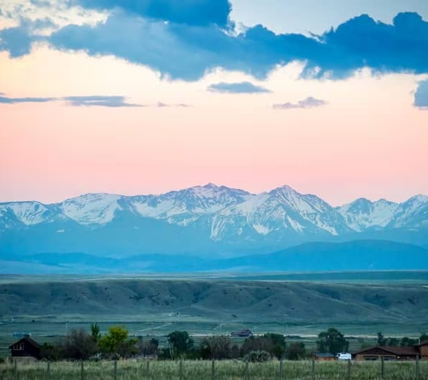 Distant view of mountains with a pink sky in Three Forks, Montana.