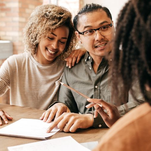 A couple with a real estate agent, potentially engaging in property discussions or viewings.