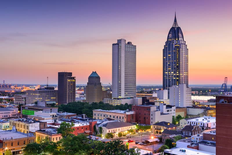 RHB Assets From IGX: Mobile, Alabama skyline with waterfront buildings and a blue sky.