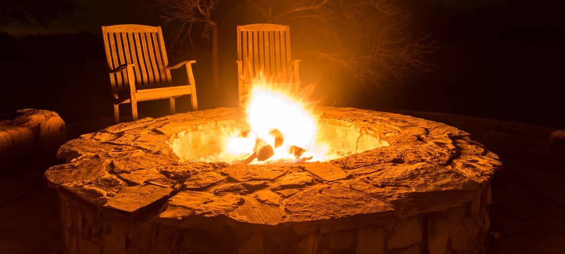 RHB Assets From IGX: Cozy outdoor fire pit surrounded by chairs in a backyard