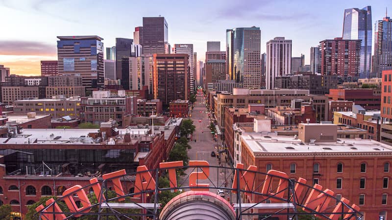 RHB Assets From IGX: Union Station in Denver, Colorado with a view of the city skyline.