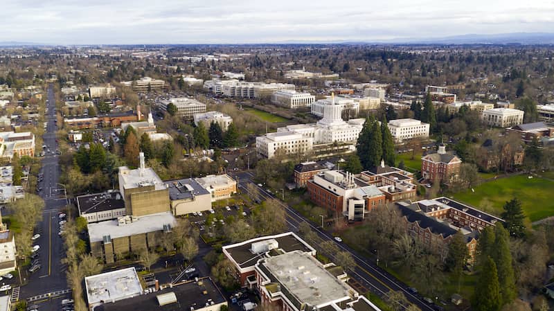 RHB Assets From IGX: Scenic view of downtown Salem, Oregon with a river and greenery.