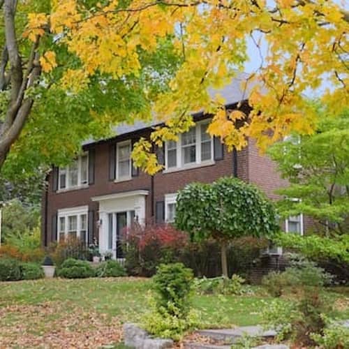 Two story brick home on wooded lot.