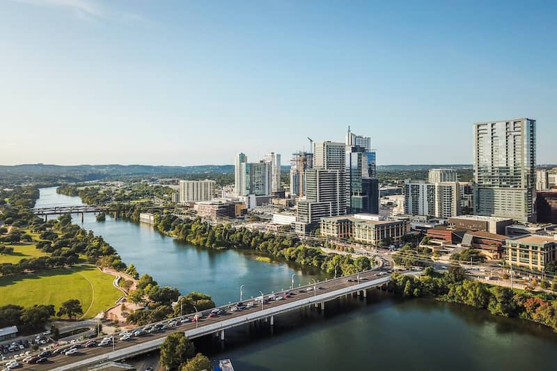 RHB Assets From IGX: An aerial view of Austin, Texas, with the Congress Avenue Bridge in the foreground.