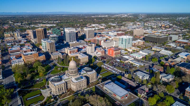 RHB Assets From IGX: Scenic view of Boise, Idaho, featuring mountains, trees, and a river.