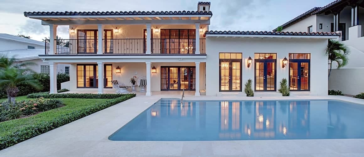 Modern luxury home with multi level balcony overlooking onto pool.