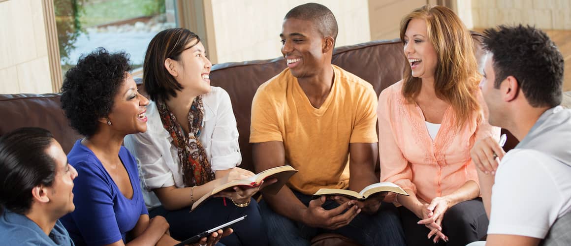 A small group of young adults with books, potentially indicating studying or learning activities among peers.
