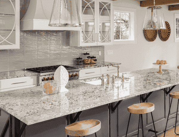 A beautiful kitchen island with bar stools and granite top.