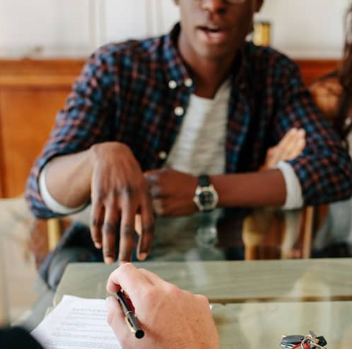 A couple meeting with a tax advisor, potentially discussing financial or real estate planning with a professional.