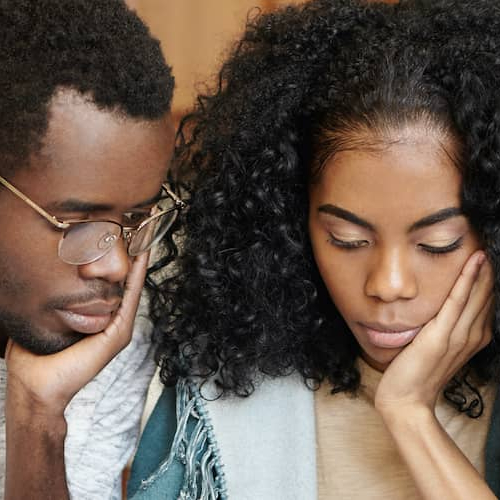 A couple reviewing escrow documents, possibly related to a real estate transaction or property purchase.