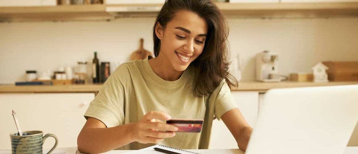 Arab-American woman smiling while on computer.