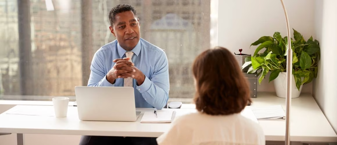 Customer meeting with financial advisor in office.