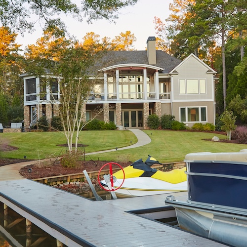 House on lakefront with dock and small boat in Georgia.