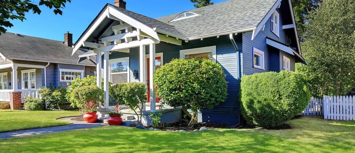 Image of a small blue house, possibly representing a residential property.