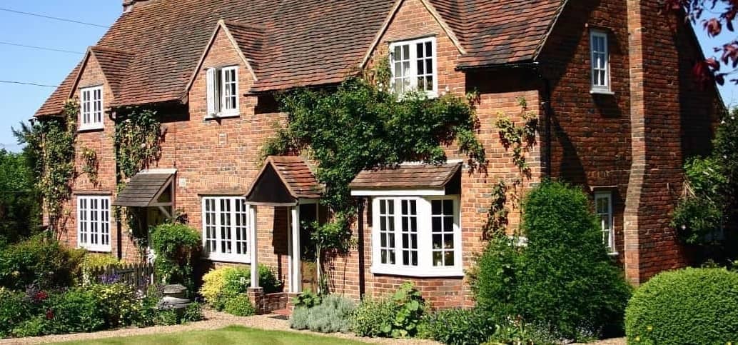 A vintage cottage-style brick home, highlighting its nostalgic and traditional appearance.