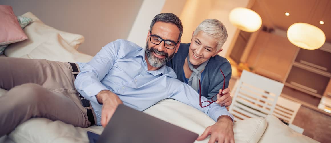 RHB Assets From IGX: Happy retired older couple looking at a computer